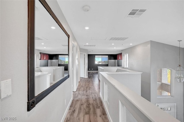 5823 Rose Sage St, North Las Vegas, NV 89031 - hall featuring light wood-type flooring, an upstairs landing, and recessed lighting