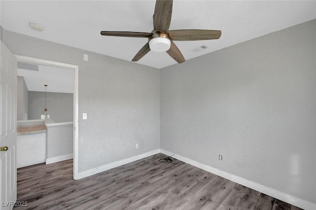 5823 Rose Sage St, North Las Vegas, NV 89031 - empty room with a ceiling fan, wood finished floors, and a smoke detector