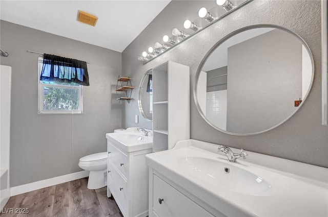 5823 Rose Sage St, North Las Vegas, NV 89031 - full bathroom featuring two vanities and wood finished floors