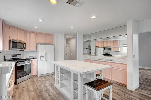 5823 Rose Sage St, North Las Vegas, NV 89031 - kitchen with appliances with stainless steel finishes, light wood-style floors, a center island, recessed lighting, and open shelves