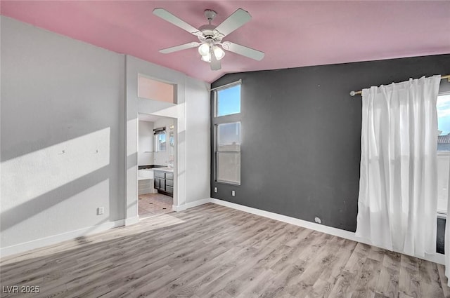 5823 Rose Sage St, North Las Vegas, NV 89031 - unfurnished bedroom with light wood-style floors, lofted ceiling, ensuite bath, and a ceiling fan