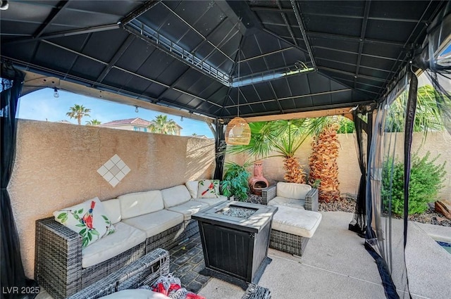 5823 Rose Sage St, North Las Vegas, NV 89031 - fenced backyard with an outdoor living space with a fire pit and a patio