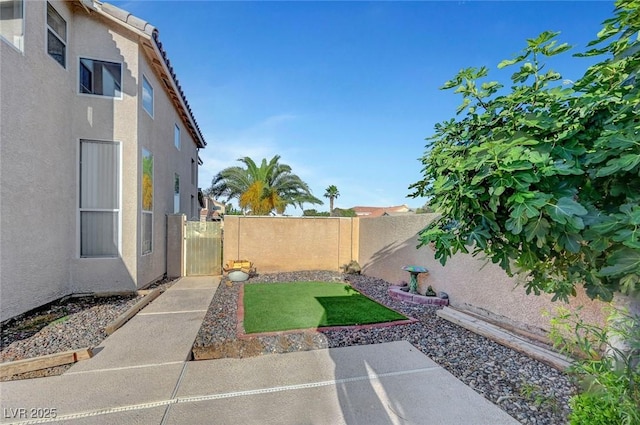 5823 Rose Sage St, North Las Vegas, NV 89031 - fenced backyard with a patio area and a gate