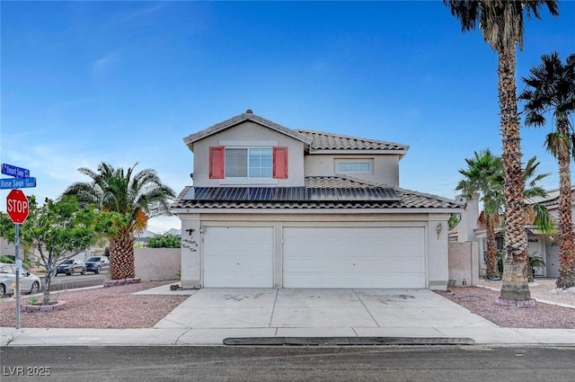 5823 Rose Sage St, North Las Vegas, NV 89031 - traditional-style house featuring an attached garage, concrete driveway, stucco siding, and a tile roof