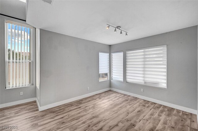 5823 Rose Sage St, North Las Vegas, NV 89031 - empty room featuring wood finished floors and rail lighting