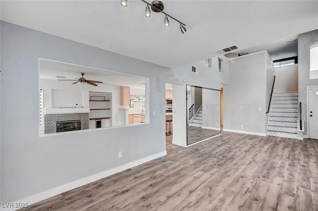 5823 Rose Sage St, North Las Vegas, NV 89031 - unfurnished living room featuring stairs, wood finished floors, and a ceiling fan