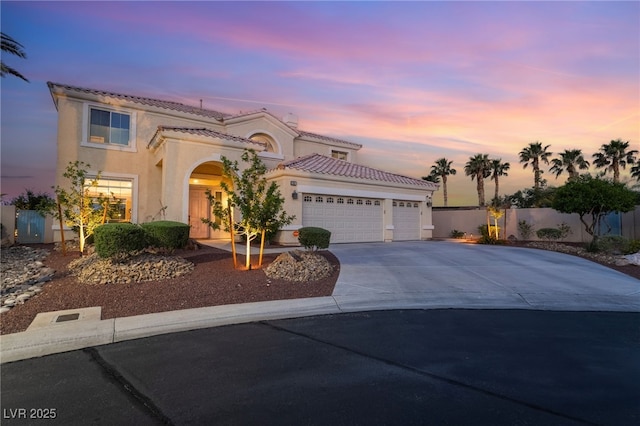 352 Angels Trace Ct, Las Vegas, NV 89148 - mediterranean / spanish house with a tiled roof, driveway, a garage, and stucco siding