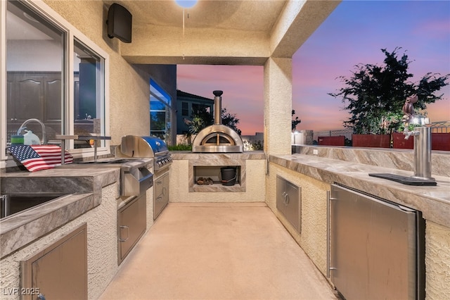352 Angels Trace Ct, Las Vegas, NV 89148 - patio terrace at dusk featuring area for grilling and a patio