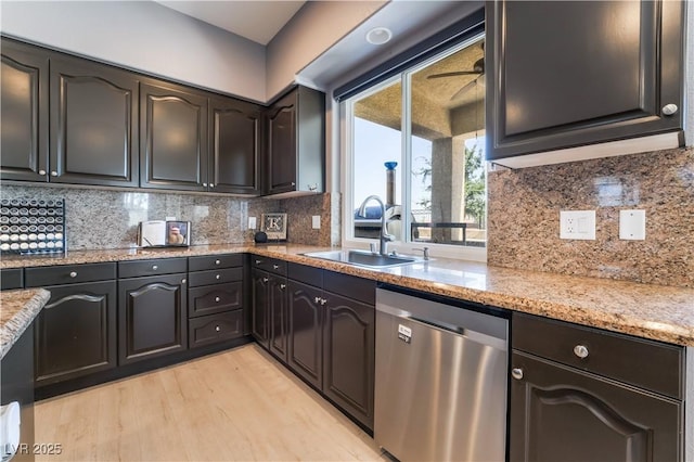 352 Angels Trace Ct, Las Vegas, NV 89148 - kitchen featuring stainless steel dishwasher, light wood-type flooring, light stone counters, and backsplash