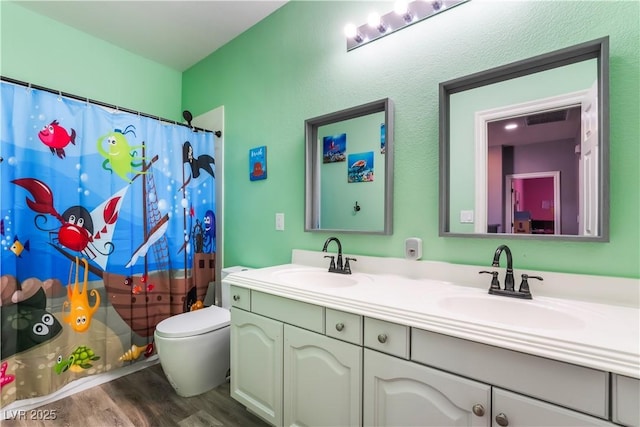 352 Angels Trace Ct, Las Vegas, NV 89148 - full bathroom featuring double vanity, wood finished floors, and a shower with shower curtain