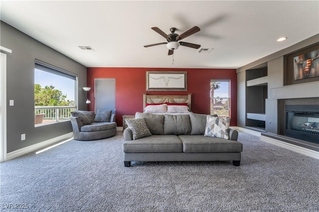 352 Angels Trace Ct, Las Vegas, NV 89148 - carpeted living area featuring ceiling fan, built in features, and a glass covered fireplace