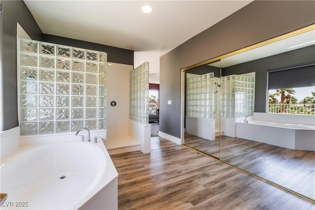 352 Angels Trace Ct, Las Vegas, NV 89148 - bathroom with a bath, a walk in shower, and wood finished floors