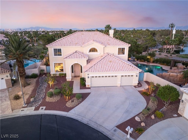 352 Angels Trace Ct, Las Vegas, NV 89148 - mediterranean / spanish-style home with a garage, a tiled roof, stucco siding, concrete driveway, and a chimney