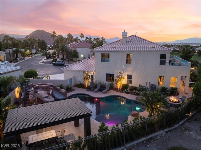 352 Angels Trace Ct, Las Vegas, NV 89148 - view of swimming pool featuring an outdoor fire pit, a patio, and a mountain view