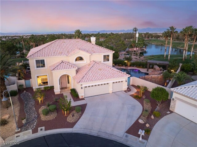 352 Angels Trace Ct, Las Vegas, NV 89148 - mediterranean / spanish home with a tile roof, a garage, driveway, stucco siding, and a water view