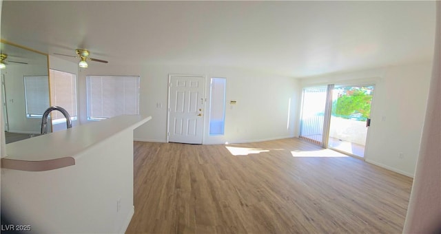3425 E Russell Rd Unit 265, Las Vegas, NV 89120 - unfurnished living room featuring ceiling fan and light wood finished floors