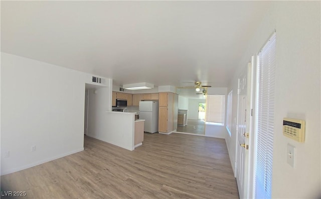 3425 E Russell Rd Unit 265, Las Vegas, NV 89120 - unfurnished living room with light wood-style floors and ceiling fan