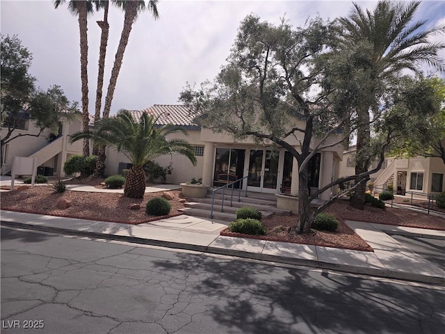 3425 E Russell Rd Unit 265, Las Vegas, NV 89120 - view of front facade featuring stairway, stucco siding, and a tile roof