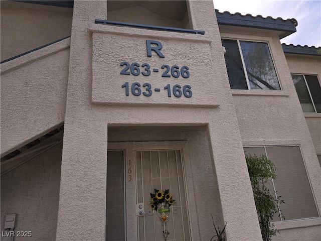 3425 E Russell Rd Unit 265, Las Vegas, NV 89120 - doorway to property with stucco siding and a tiled roof