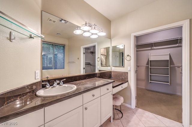 10300 Wellside Hill Ave, Las Vegas, NV 89145 - bathroom with tile patterned flooring, vanity, and a spacious closet