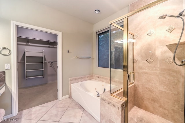 10300 Wellside Hill Ave, Las Vegas, NV 89145 - full bathroom featuring a bath, a shower stall, a walk in closet, and tile patterned floors