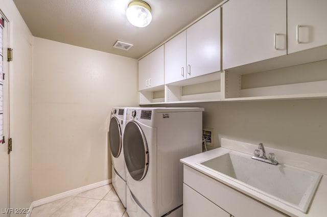 10300 Wellside Hill Ave, Las Vegas, NV 89145 - laundry room featuring independent washer and dryer, cabinet space, and light tile patterned floors