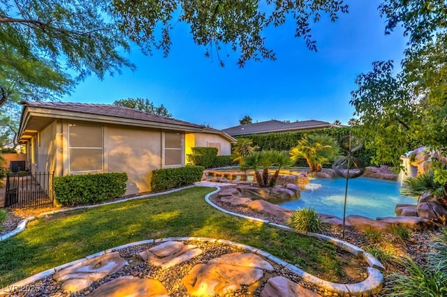 10300 Wellside Hill Ave, Las Vegas, NV 89145 - back of house featuring stucco siding and a yard