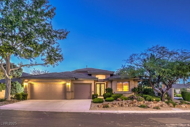 10300 Wellside Hill Ave, Las Vegas, NV 89145 - view of front facade with a garage, driveway, and stucco siding