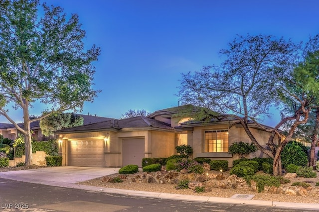 10300 Wellside Hill Ave, Las Vegas, NV 89145 - view of front of property with an attached garage, driveway, and stucco siding