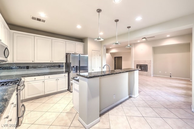 10300 Wellside Hill Ave, Las Vegas, NV 89145 - kitchen featuring appliances with stainless steel finishes, light tile patterned flooring, white cabinetry, pendant lighting, and recessed lighting