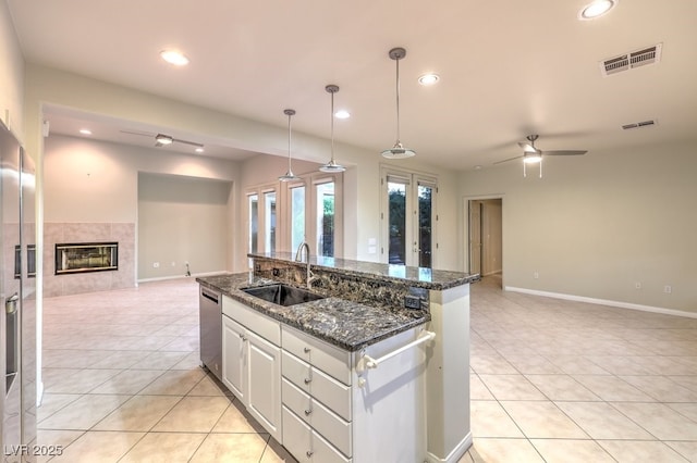 10300 Wellside Hill Ave, Las Vegas, NV 89145 - kitchen featuring open floor plan, light tile patterned floors, stainless steel dishwasher, a fireplace, and recessed lighting