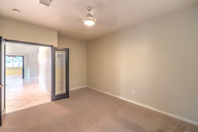 10300 Wellside Hill Ave, Las Vegas, NV 89145 - unfurnished room featuring a smoke detector, a ceiling fan, light colored carpet, and light tile patterned floors