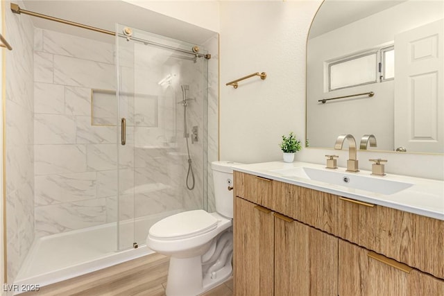 3748 Silent Hill Dr, Las Vegas, NV 89147 - bathroom featuring a marble finish shower, vanity, and wood finished floors