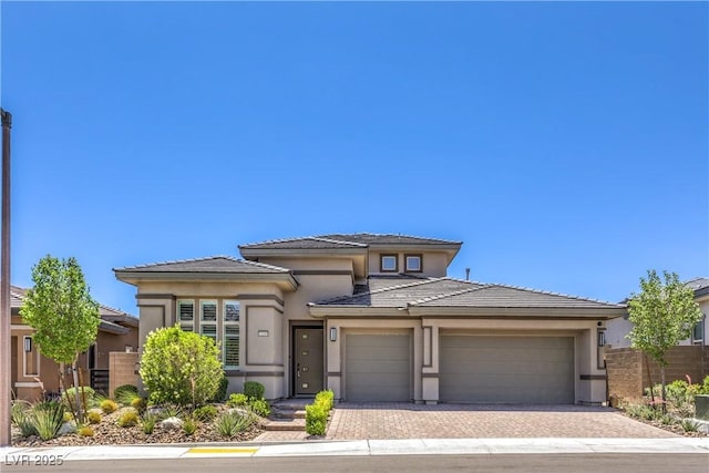 12295 Skyracer Dr, Las Vegas, NV 89138 - prairie-style home with stucco siding, driveway, an attached garage, and a tile roof