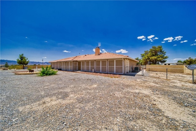 3251 S Parkridge Ave, Pahrump, NV 89048 - rear view of property featuring a chimney and a sunroom