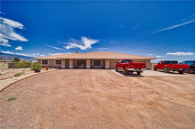 3251 S Parkridge Ave, Pahrump, NV 89048 - ranch-style home with driveway, an attached garage, and stucco siding