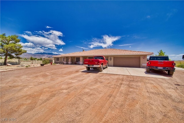 3251 S Parkridge Ave, Pahrump, NV 89048 - single story home with an attached garage, driveway, stucco siding, and a mountain view