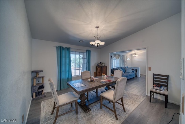 3251 S Parkridge Ave, Pahrump, NV 89048 - dining area with a chandelier, vaulted ceiling, and wood finished floors