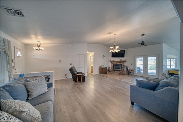 3251 S Parkridge Ave, Pahrump, NV 89048 - living room featuring a chandelier, a fireplace, light wood-style flooring, and lofted ceiling