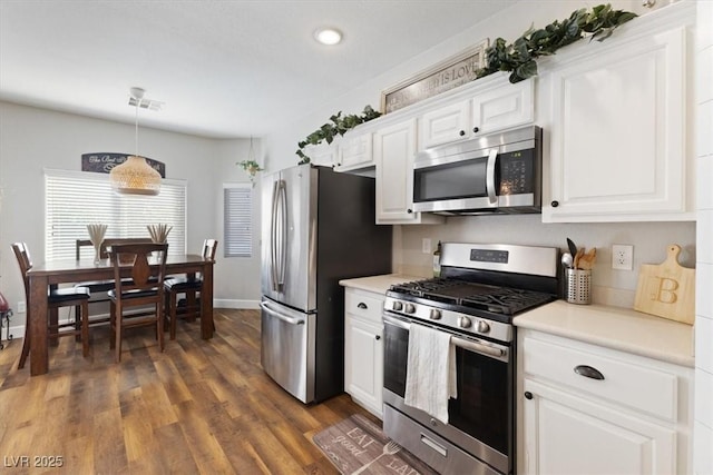 5131 Moose Falls Dr, Las Vegas, NV 89141 - kitchen with appliances with stainless steel finishes, light countertops, white cabinetry, dark wood-style flooring, and recessed lighting
