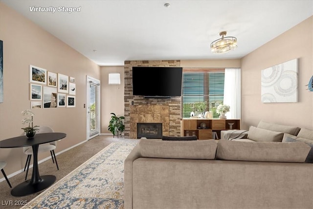 5855 Valley Dr Unit 2130, North Las Vegas, NV 89031 - carpeted living room with baseboards and a large fireplace