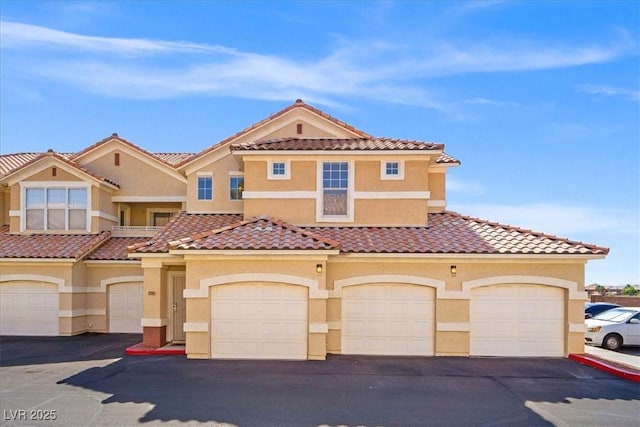 5855 Valley Dr Unit 2130, North Las Vegas, NV 89031 - view of front of house with stucco siding and a tile roof