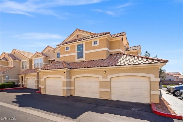5855 Valley Dr Unit 2130, North Las Vegas, NV 89031 - view of front facade with stucco siding and a tile roof