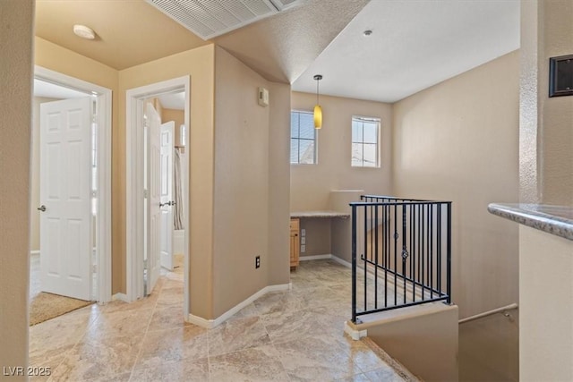 5855 Valley Dr Unit 2130, North Las Vegas, NV 89031 - hallway featuring an upstairs landing and baseboards
