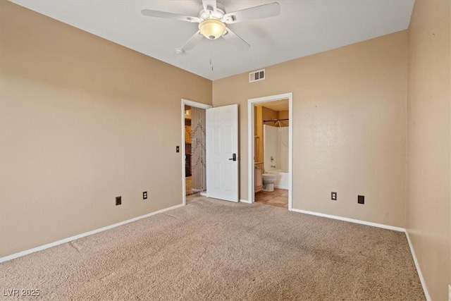 5855 Valley Dr Unit 2130, North Las Vegas, NV 89031 - unfurnished bedroom featuring light carpet, ensuite bathroom, and a ceiling fan