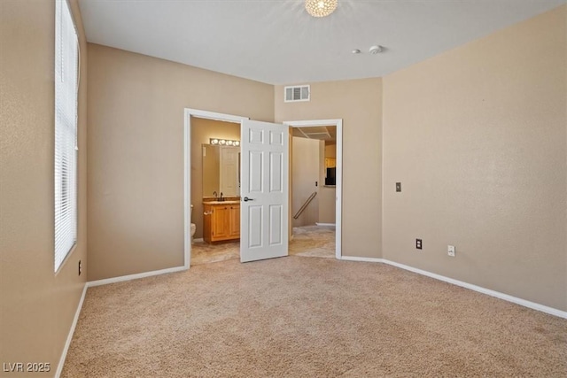 5855 Valley Dr Unit 2130, North Las Vegas, NV 89031 - unfurnished bedroom featuring light colored carpet and ensuite bath