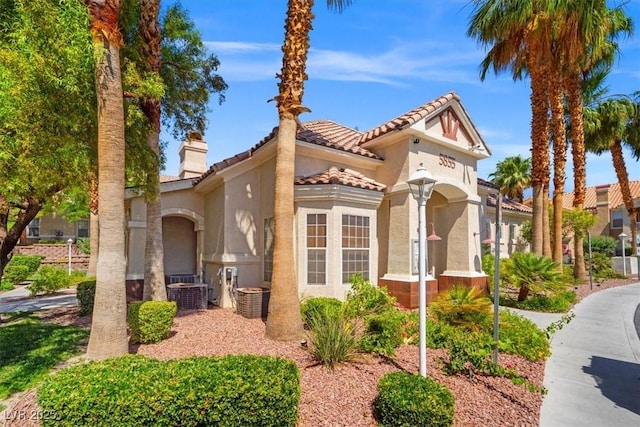 5855 Valley Dr Unit 2130, North Las Vegas, NV 89031 - mediterranean / spanish-style house featuring stucco siding, a chimney, and a tiled roof