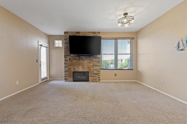 5855 Valley Dr Unit 2130, North Las Vegas, NV 89031 - unfurnished living room with a fireplace, healthy amount of natural light, and carpet flooring