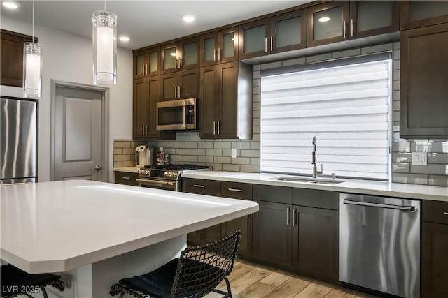 8175 Caldera Creek St, Las Vegas, NV 89113 - kitchen with appliances with stainless steel finishes, light countertops, tasteful backsplash, a breakfast bar area, and recessed lighting