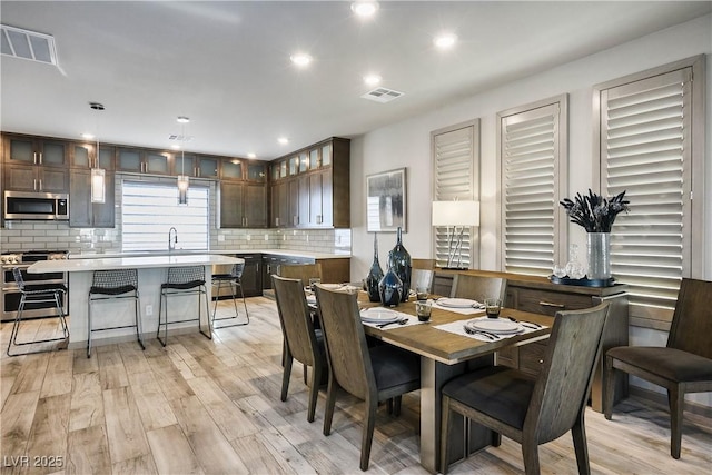 8175 Caldera Creek St, Las Vegas, NV 89113 - dining area with light wood-type flooring and recessed lighting